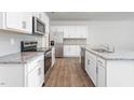 Modern kitchen featuring white cabinets, granite countertops, and stainless steel appliances at 1819 Hinesley Dr, Durham, NC 27703