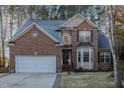Two-story brick home with a large driveway and landscaped lawn at 3100 Lariat Ridge Dr, Wake Forest, NC 27587