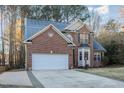 Brick home with a two-car garage and neat landscaping at 3100 Lariat Ridge Dr, Wake Forest, NC 27587