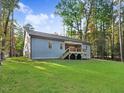 Gray house with deck and large backyard at 652 Shawnee Dr, Louisburg, NC 27549