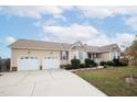Two-car garage and well-manicured lawn at 7217 Blannie Farms Ln, Willow Springs, NC 27592