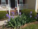 Landscaped front yard with blooming purple irises at 7217 Blannie Farms Ln, Willow Springs, NC 27592