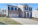 Two-story house with gray siding, a two-car garage, and a manicured lawn at 80 Bella Vita Way, Angier, NC 27501