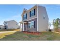 Two-story house with gray siding, and a landscaped yard at 80 Bella Vita Way, Angier, NC 27501