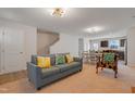 Open living room with a gray couch and a view of the kitchen at 80 Bella Vita Way, Angier, NC 27501