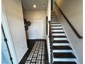 Bright entryway with dark hardwood floors, staircase, and a view of an interior door at 2243 Horton Park Drive, Apex, NC 27539