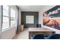 Modern home office with wood desk, large wall art, and window with curtains at 2243 Horton Park Drive, Apex, NC 27539
