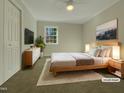 Virtually staged bedroom with light wood bed frame and neutral decor at 302 N Montreal Ct, Cary, NC 27511