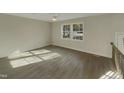 Bright living room with hardwood floors and large windows at 302 N Montreal Ct, Cary, NC 27511