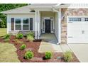 Inviting front entrance with stone facade and covered porch at 51 Sunburst Ct, Fuquay Varina, NC 27526