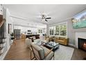 Open living space with fireplace, large windows, and modern furniture at 517 Shawnee Dr, Louisburg, NC 27549
