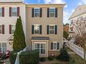 Tan three story townhome with multiple windows and landscaping at 1120 Renewal Place # 108, Raleigh, NC 27603