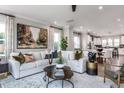 Open living space with sectional sofa, coffee table, and kitchen views at 1212 Holding Village Way, Wake Forest, NC 27587