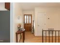 Bright entryway with hardwood floors and coat closet at 5829 Sandstone Dr, Durham, NC 27713