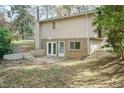 Back exterior view with patio and access to the basement at 5829 Sandstone Dr, Durham, NC 27713