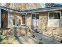 Brick front entry with decorative planters and landscaping at 5829 Sandstone Dr, Durham, NC 27713