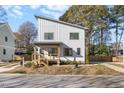 Modern two-story home with white siding, a deck, and street parking at 2503 Lednum St, Durham, NC 27704