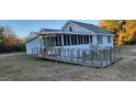 Front exterior of a house with a wooden ramp leading to a screened porch at 332 Bass Lake Road Rd, Holly Springs, NC 27540