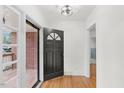 Bright entryway with hardwood floors and a view of the front porch at 303 Forest Rd, Oxford, NC 27565