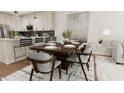 Dining area features a wood table and modern chairs near the kitchen at 4041 Elk Creek Ln # 16, Raleigh, NC 27612