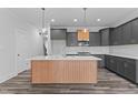 Modern kitchen with gray cabinetry, large island, and white countertops at 507 Excelsior Ct, Rolesville, NC 27587