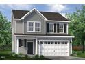 Two-story house with gray siding, white garage door and landscaping at 96 Brooklynn Trl, Angier, NC 27501