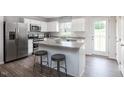 Island kitchen with stainless steel appliances and granite countertops at 481 Autumn Moon Dr, Zebulon, NC 27597