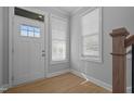 Bright entryway with white door, wood floors, and neutral walls at 709 Jamescroft Way, Rolesville, NC 27587