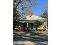 A fixer-upper home with a white exterior, a slightly sloped roof, and a small porch at 762 Nashville Rd, Rocky Mount, NC 27803
