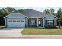 Charming one-story home with gray siding and stone accents at 115 Lemon Drop Ln, Franklinton, NC 27525