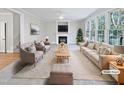Virtually staged living room featuring a fireplace and ample natural light at 4700 Linaria Ln, Fuquay Varina, NC 27526