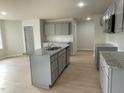 Modern kitchen with gray cabinets, granite counters, and island at 172 Tulipfield Way, Benson, NC 27504