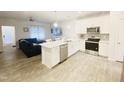 Modern kitchen with white cabinets, stainless steel appliances, and an island at 242 Liam St, Clayton, NC 27520