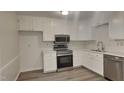 Modern kitchen with stainless steel appliances and white cabinets at 111 Whithorne Dr, Garner, NC 27529