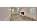 Bright living room featuring a fireplace and door to backyard at 111 Whithorne Dr, Garner, NC 27529