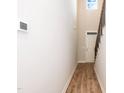 Hallway with wood-look flooring, white walls, and staircase at 807 E Harnett St, Dunn, NC 28334