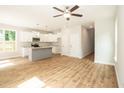 Open concept kitchen and living area with wood-look flooring at 807 E Harnett St, Dunn, NC 28334