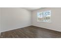 Simple bedroom with hardwood floors and a large window at 900 Canis Minor Rd, Wendell, NC 27591