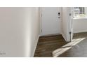 Bright entryway with hardwood floors and a modern door at 900 Canis Minor Rd, Wendell, NC 27591
