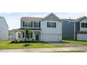 Two-story house with gray and white siding, a gray door, and a two-car garage at 920 Canis Minor Rd, Wendell, NC 27591