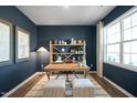 Home office with dark blue walls, built-in shelving, and a wood desk at 928 Canis Minor Rd, Wendell, NC 27591