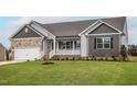 Two-car garage and nicely landscaped lawn at 11300 International Dr, Middlesex, NC 27557