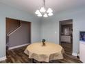 Round dining table with a beige tablecloth, chandelier, and view of kitchen at 333 Bald Head Island Dr, Garner, NC 27529