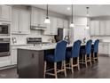 Modern kitchen with stainless steel appliances and a large island at 604 Mohinda Way, Willow Springs, NC 27592