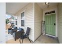 Inviting front porch with two wicker chairs and a welcome sign at 82 Mariners Point Way, Garner, NC 27529