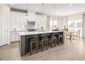 Modern kitchen with white cabinets, stainless steel appliances, and an island at 8913 Stratus St, Willow Springs, NC 27592