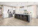 Modern kitchen with white cabinets, stainless steel appliances, and an island at 8913 Stratus St, Willow Springs, NC 27592
