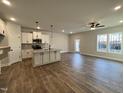 Bright living room with hardwood floors and access to kitchen at 91 Calluna Dr, Clayton, NC 27520