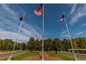 Three flags fly proudly at the community entrance at 129 Mayan Dr, Louisburg, NC 27549