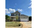 Two-story house with gray siding, white garage door, and landscaping at 40 Misty Mountain, Spring Hope, NC 27882